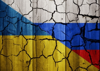 Cracked Wall With Russian And Ukrainian Flags