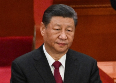 China's President Xi Jinping applauds during the opening session